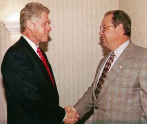 Bob Monica shaking hands with former President, Bill Clinton.