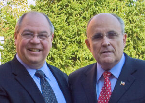 Bob Monica standing to the left of Rudy Giuliani.