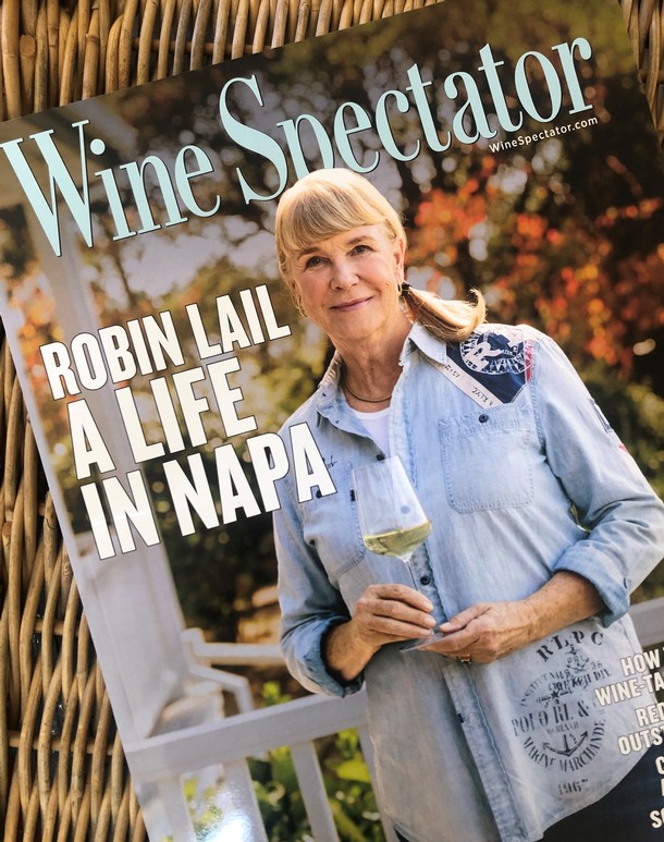A cover of Wine Spectator with a woman on front standing and holding a glass of wine.