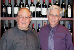 Bob Monica in a dark gray collared shirt standing to the left of Pat Roney who is wearing a purple collared shirt.