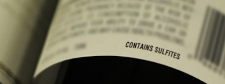 A lable where the only words which are readable are "Contains Sulfites."
